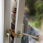 Einbrecher an einem Fenster